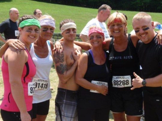 Group of friends before running a three mile mud-obstacle course